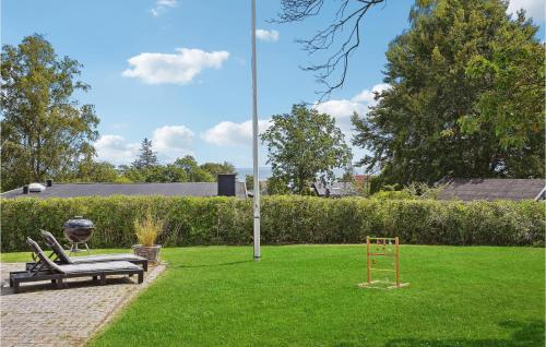 a park with two benches and a playground at 4 Bedroom Cozy Home In Odder in Odder