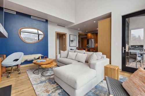 a living room with a white couch and a table at Riverfront Lodge 308 by East West Hospitality in Beaver Creek