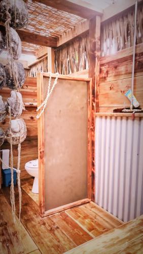 a bathroom with a door in the middle of a room at Sunset rooms - Auberge Polynésienne in Tevaitoa