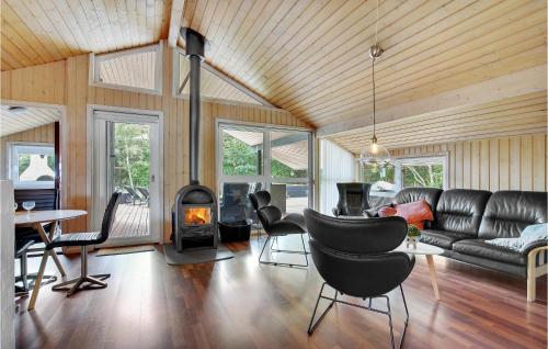 a living room with a couch and a fireplace at Lovely Home In Saltum With Kitchen in Saltum