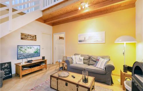 a living room with a couch and a tv at Seebrise in Süssau