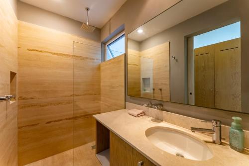 a bathroom with a sink and a mirror at Papaya 15 Apartments in Playa del Carmen