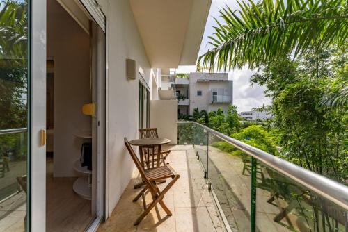 a balcony with a chair and a view of the city at Papaya 15 Apartments in Playa del Carmen
