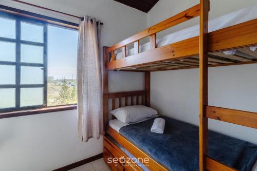 a bedroom with two bunk beds and a window at Casa c/ Piscina na Praia da Dunas PDU0033 in Škorak