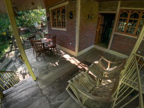 an open porch with chairs and a table on a house at Congos Lodge in El Perú