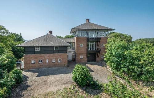 a large brick house with a balcony on top of it at Holiday Home Ristingevej Humble Ii in Humble