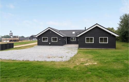 a black house with a large yard at Nice Home In Sydals With Kitchen in Sarup