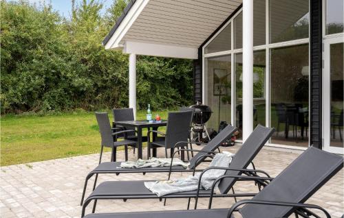 a group of chairs and a table on a patio at Nice Home In Sydals With Kitchen in Sarup