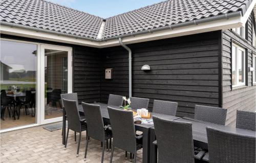 a dining room with a table and chairs on a patio at Nice Home In Sydals With Kitchen in Sarup