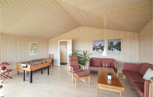 a living room with a table and a chess board at Three-Bedroom Holiday Home In Orsted in Ørsted