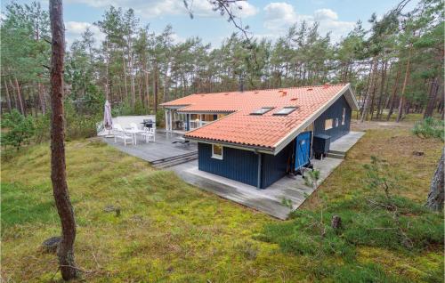 an overhead view of a blue house in the woods at Stunning Home In Nexø With Kitchen in Vester Sømarken