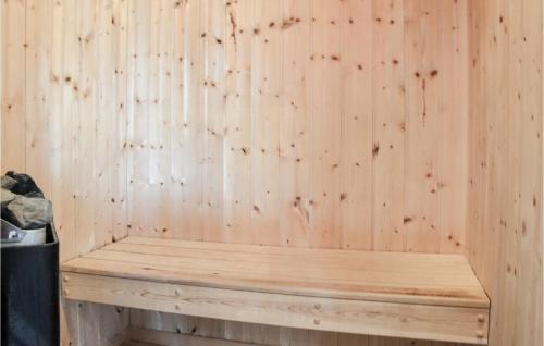 a wooden bench against a wooden wall in a sauna at Holiday Home Lerager in Gilleleje