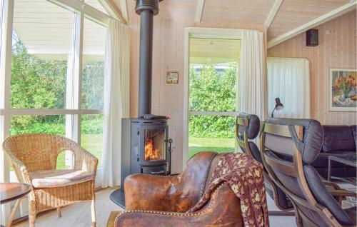 a living room with a couch and a wood stove at Holiday Home Lerager in Gilleleje