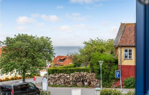 a view of a street in a town with a stone wall at 3 Bedroom Nice Apartment In Allinge in Allinge