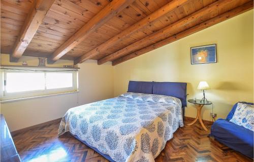 a bedroom with a bed in a room with a wooden ceiling at Amazing Home In Marina Di Modica in Marina di Modica