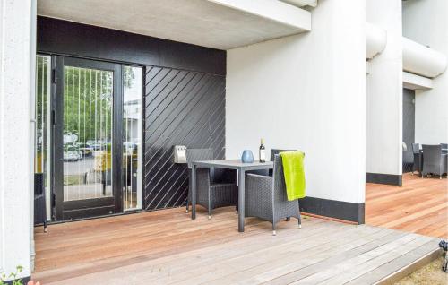 a patio with a table and chairs on a deck at Studio Apartment In Helsingor in Helsingør
