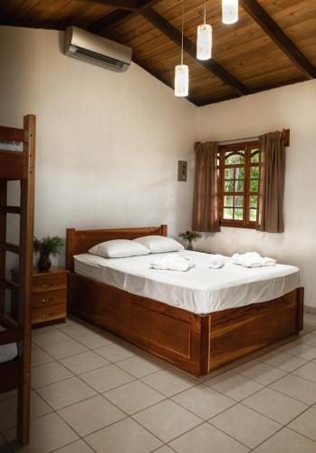 a bedroom with a large wooden bed in a room at Congos Lodge in El Perú