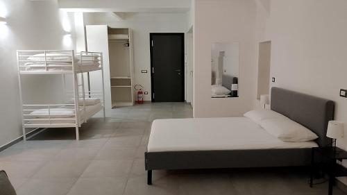 a bedroom with a bed and a bunk bed at Sotto la torre appartamento in Fiano Romano