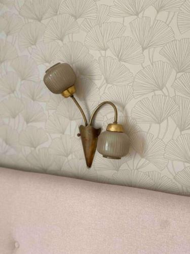 a couple of lights on a wall with a wallpaper at Beautiful, Central Emek Refaim Home in Yerushalayim