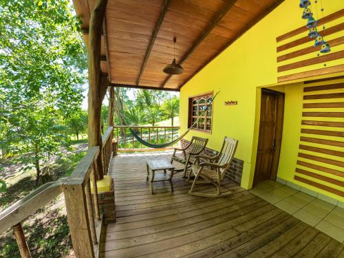a wooden deck with chairs and a table on it at Congos Lodge in El Perú