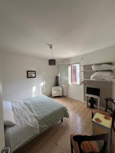 a bedroom with a bed and a desk and a piano at Casa vacanze Manzoni 289 in Perugia