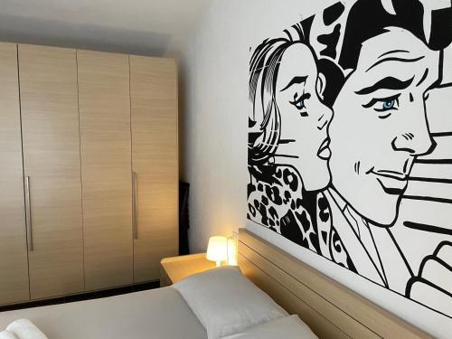 a bedroom with a black and white painting on the wall at Cav Pop Sky in Seregno