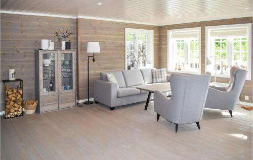 a living room with a couch and a table and chairs at Lovely Home In Passebekk With Wifi in Omholt