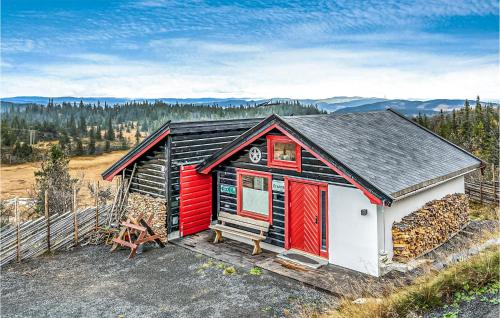 a red and white cabin with a bench in front of it at Nice Home In Reinli With Kitchen in Reinli