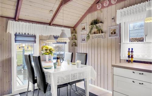 a kitchen with a white table and chairs at 2 Bedroom Nice Home In Hemmet in Hemmet