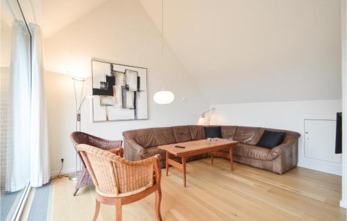 a living room with a couch and a table at Two-Bedroom Holiday Home In Romo in Sønderby