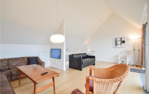 a living room with a couch and a table at Two-Bedroom Holiday Home In Romo in Sønderby