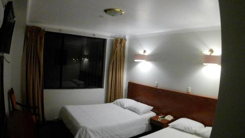 Ein Bett oder Betten in einem Zimmer der Unterkunft QASANA HOTEL Plaza Calca