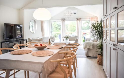 a kitchen and dining room with a table and chairs at Cozy Home In Yngsjö With Kitchen in Yngsjö