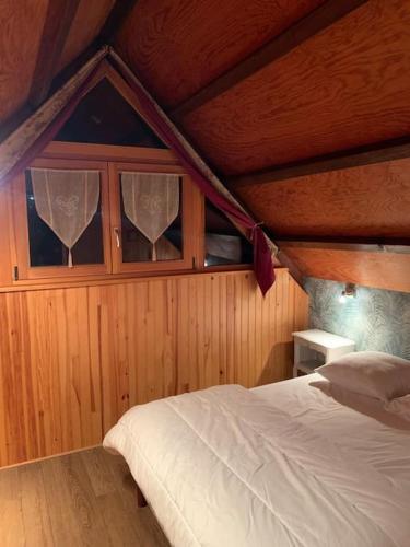 - une chambre avec un lit et 2 fenêtres avec des rideaux dans l'établissement L'atout coeur, à Ban-sur-Meurthe-Clefcy