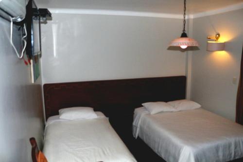 Ein Bett oder Betten in einem Zimmer der Unterkunft QASANA HOTEL Plaza Calca
