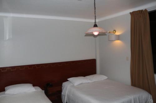 Ein Bett oder Betten in einem Zimmer der Unterkunft QASANA HOTEL Plaza Calca
