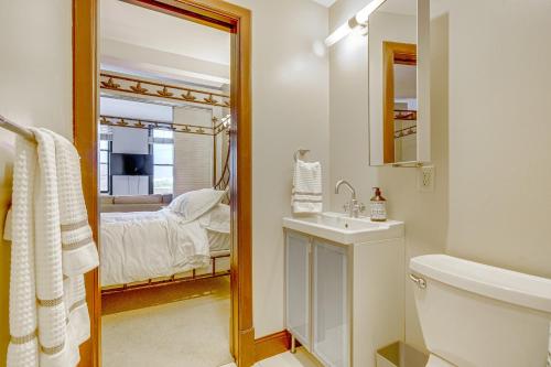 a bathroom with a sink and a toilet and a mirror at Walk to Convention Center, Secured Apt in Columbus in Columbus