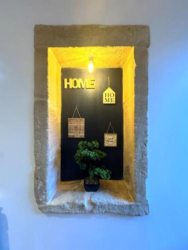 a picture of a house with a tree in a window at Entre Parenthèse in Lion-sur-Mer
