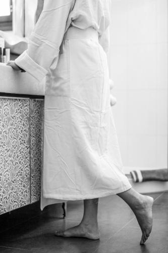 a woman in apron standing in front of a counter at Villa Alyko in Aliko Beach