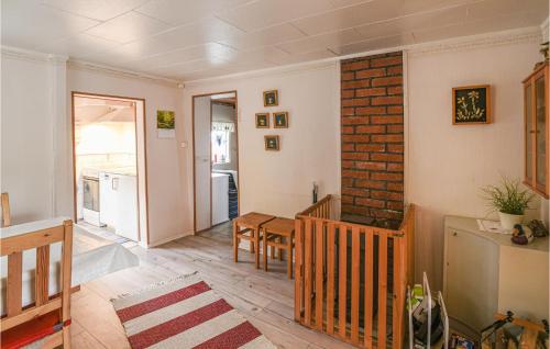 a living room with a table and a brick wall at Two-Bedroom Holiday Home In Tived in Tived