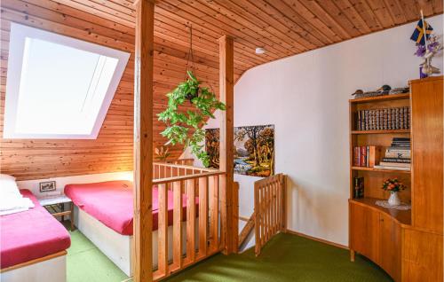 a bedroom with a bed and a book shelf at Two-Bedroom Holiday Home In Tived in Tived