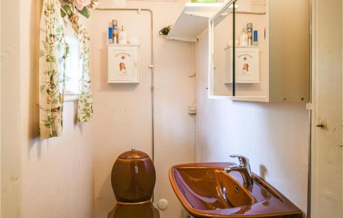 a bathroom with a sink and a toilet at Two-Bedroom Holiday Home In Tived in Tived