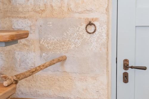 a wooden bat hanging on a wall next to a door at I Giardini di Pomona in Cisternino