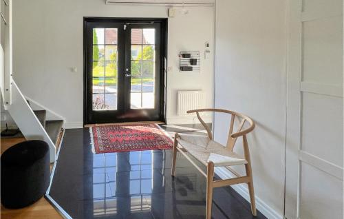 a room with a table and a chair and a window at Gorgeous Home In Dalsjöfors With Sauna in Dalsjöfors
