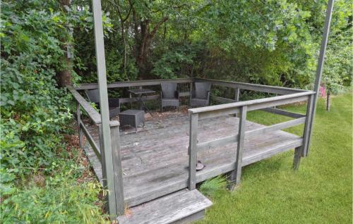 a wooden bridge with a bench and a table at Amazing Home In Ansager With Lake View in Ansager