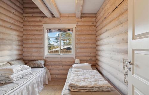 a room with two beds in a log cabin at Nice Home In Hornbæk With Wifi in Hornbæk