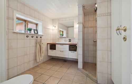 a bathroom with a shower and a sink and a toilet at Awesome Home In Gudhjem With Wifi in Gudhjem