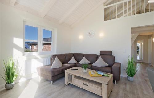 a living room with a couch and a coffee table at Stunning Home In Dagebüll With Sauna in Dagebüll