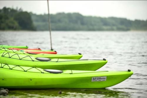 a row of lime green canoes on a lake at Retreat in Tulfarris County Wicklow - Ireland in Blessington