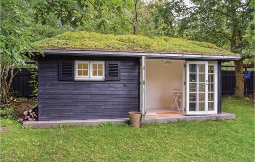 a small blue shed with a grass roof at 5 Bedroom Lovely Home In Hornbæk in Hornbæk
